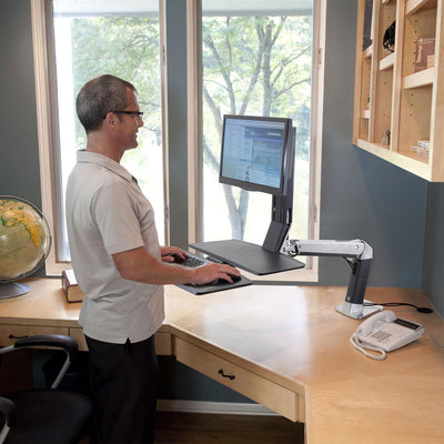 Ergotron Sit-Stand Desk Arm 24-317-026, person using the workstation at standing height