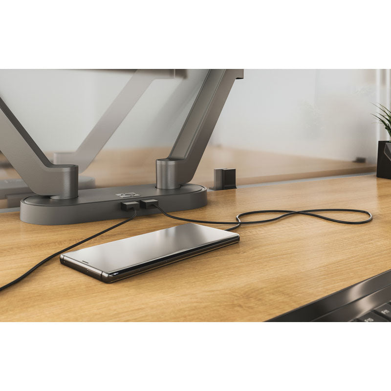 Chief Koncis USB Charging Hub D2US-NA, desk-mounted monitor stand hub charging a smartphone