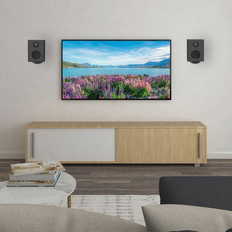Peerless-AV Universal Swivel Wall Speaker Mounts SPK812, pair of wall-mounted speakers flanking a TV