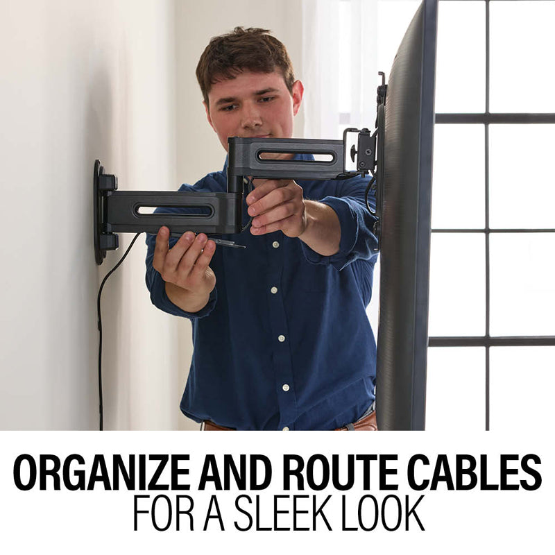 Sanus Small Adv Full-Motion 4D + Shift TV Mount VSF817-B2, person organizing cables through a wall mount