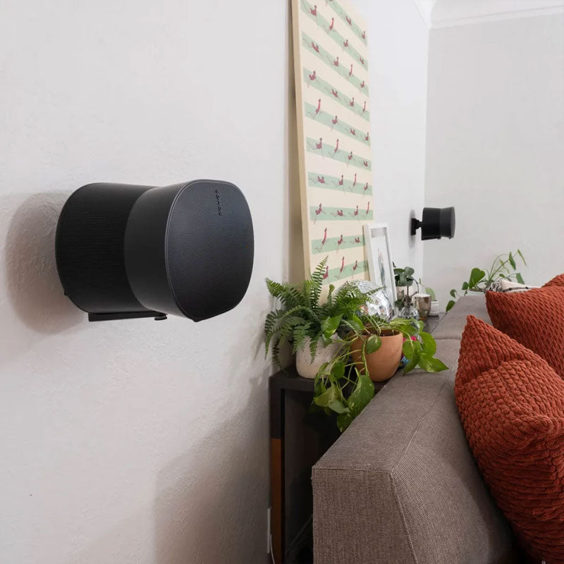 Sanus Adjustable Speaker Wall Mount WSWME31-B2, black cylindrical speaker wall-mounted in room